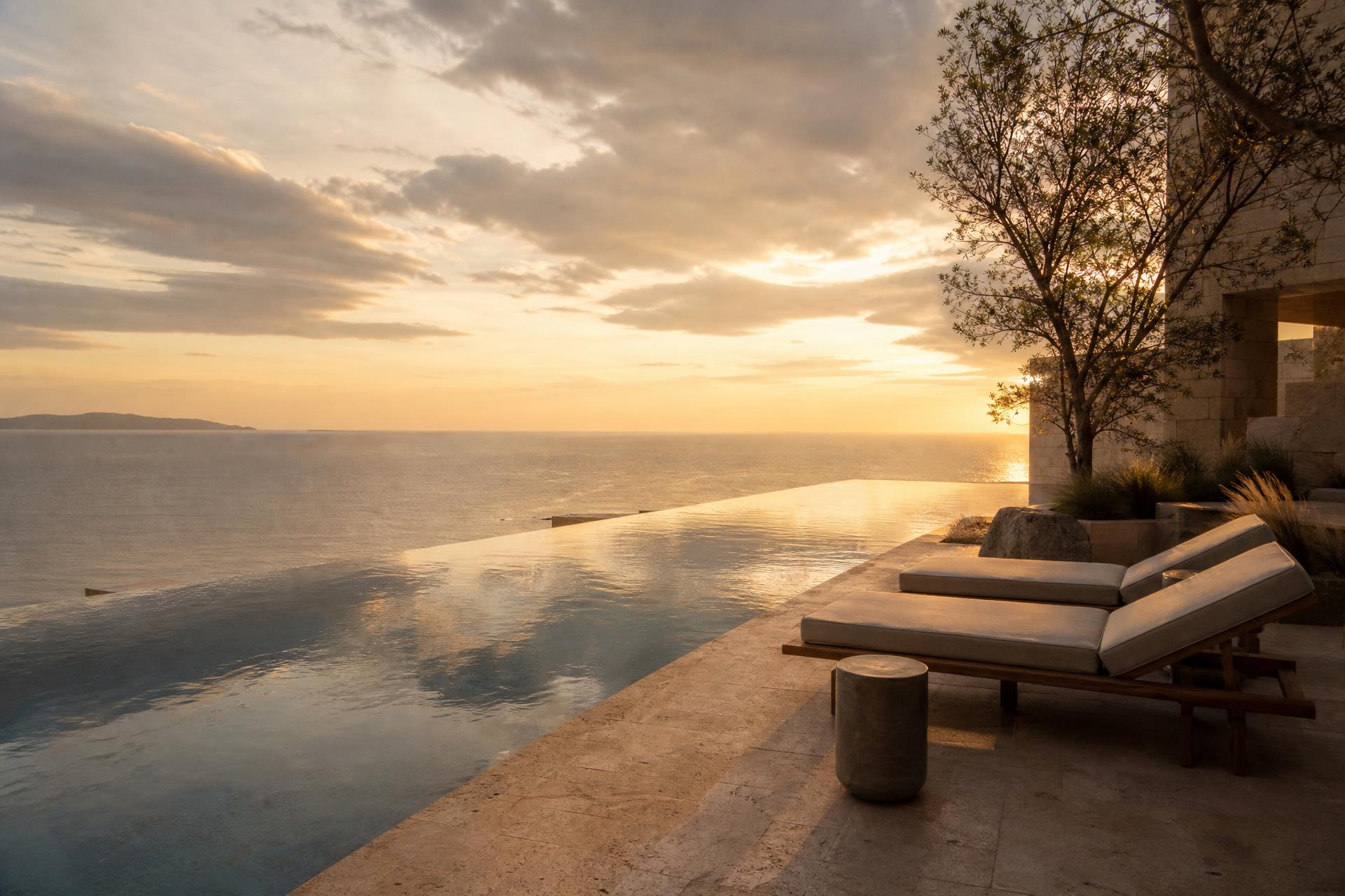 Serene private pool overlooking the coast at dusk